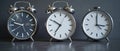 Three Different Alarm Clocks Placed on a Dark Surface