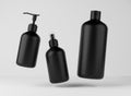 Three different black bottles for hair and body care products 3D render, set of floating cosmetic containers on gray Royalty Free Stock Photo