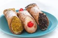 Three delicious cannoli on a blue plate, typical Sicilian pastry Royalty Free Stock Photo