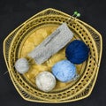 Three different colored balls of wool and the start of knitwork Royalty Free Stock Photo