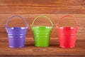 Three different colored buckets.