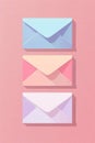 Three different colored envelopes on a pink background. Perfect for stationery or office concept Royalty Free Stock Photo