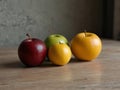 three different colored fruits are on a table one of which has a red apple Capturing the Zest