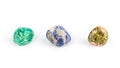 Three different colored gemstones on white background.