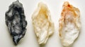 Three different colored rocks are shown on a white background Royalty Free Stock Photo