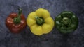 Three different colored of sweet bell peppers isolated on dark background. Red, green and yellow capsicum Royalty Free Stock Photo
