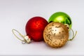 Three different coloured bauble Christmas decorations