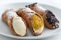 Three different delicious typical Sicilian cannoli filled with ricotta chse cream