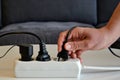 Male hand connecting an electrical plug to a power strip Royalty Free Stock Photo