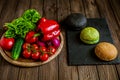 Three different hamburger buns with vegetables on wooden table. Black, green, yellow buns