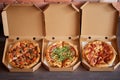 Three different kind of pizzas in delivery boxes Royalty Free Stock Photo