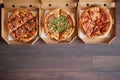 Three different kind of pizzas in delivery boxes Royalty Free Stock Photo