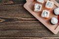 Three different kinds of Japanese rolls with wasabi and ginger on bamboo tray on beautiful wooden background Royalty Free Stock Photo