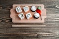 Three different kinds of Japanese rolls with wasabi and ginger on bamboo tray on beautiful wooden background Royalty Free Stock Photo
