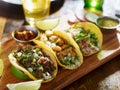 Three different mexican street tacos with beef and pork