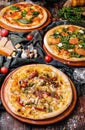 Three Different Pizzas on wooden table Royalty Free Stock Photo