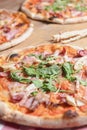 Three different pizzas on wooden table. Freshly baked traditional Italian Pizza over wooden background Royalty Free Stock Photo