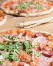 Three different pizzas on wooden table. Freshly baked traditional Italian Pizza over wooden background Royalty Free Stock Photo