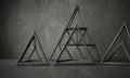 Three different shapes of triangles are shown in this image, with the largest one being a pyramid. The shapes are arrang