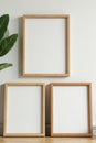 Three different sized wooden frames against a neutral wall, geometric, wall art, room Royalty Free Stock Photo