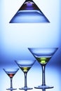 Three champagne wine glasses with colorful drinks