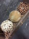 Three different style balls in wooden container