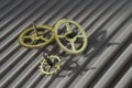 Three different toothed brass metal cog wheels
