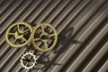 Three different toothed brass metal cog wheels