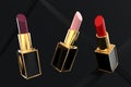 Three different tubes of lipstick on black background 3D render Royalty Free Stock Photo