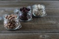 Three different varieties of beans in glass jars on an old wooden table. Colorful beans. Legumes as a source of protein. Place for