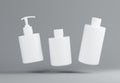 Three different white plastic cosmetic product floating bottles set template on gray background 3D render Royalty Free Stock Photo