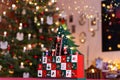 Three-dimensional Advent Calendar in Front of Christmas Tree in Christmassy illuminated Room