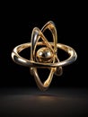 Three-dimensional Golden Atom Model Floating on a Dark Backdrop With a Smooth Surface Reflecting Light Royalty Free Stock Photo