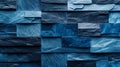 Three-dimensional wall composed of rectangular tiles. Polished blocks form textured, blue patina background. Royalty Free Stock Photo