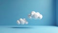 Three dimensional white fluffy clouds float in blue studio space. Abstract minimalistic background for tech or weather themes. Royalty Free Stock Photo