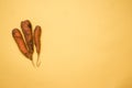 Three dirty carrots on yellow background