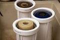Three dirty used osmosis water filter cartridges