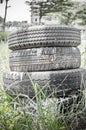 Three dirty used tires over