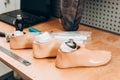 Three disassembled prosthetic foot on table in orthopedic equipment workshop, disability concept