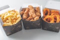 Three dishes fried snacks french frie fried chicken onion rings delivery