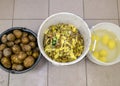 three dishes with potatoes peeled potatoes peeled and washed potatoes cooking