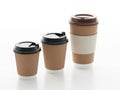 Three disposable coffee cups in different sizes isolated on white background Royalty Free Stock Photo