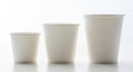 Three disposable paper cups of varying sizes showing gradual increase in volume and capacity Royalty Free Stock Photo