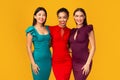 Three Diverse Ladies In Dresses Smiling And Hugging, Studio Shot
