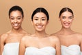 Three Diverse Ladies Models Posing In Bath Towels, Beige Background