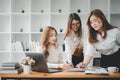 Three diverse serious businesswomen discussing business project working together in office Royalty Free Stock Photo