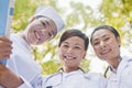 Three Doctors Smiling and Looking Down at Camera Royalty Free Stock Photo