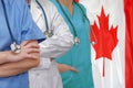 Three Doctors with stethoscope on Canada flag