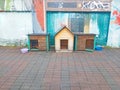 three dog kennels are on the sidewalk Royalty Free Stock Photo
