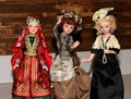 Three dolls in beautiful vintage dresses on a wooden background Royalty Free Stock Photo